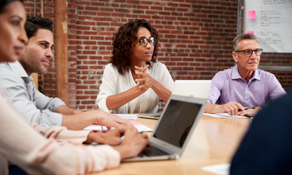 A diverse group of employees at a board room table